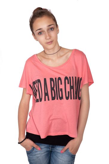 Teenage girl wearing 'I need a big change!' sign on a t-shirt